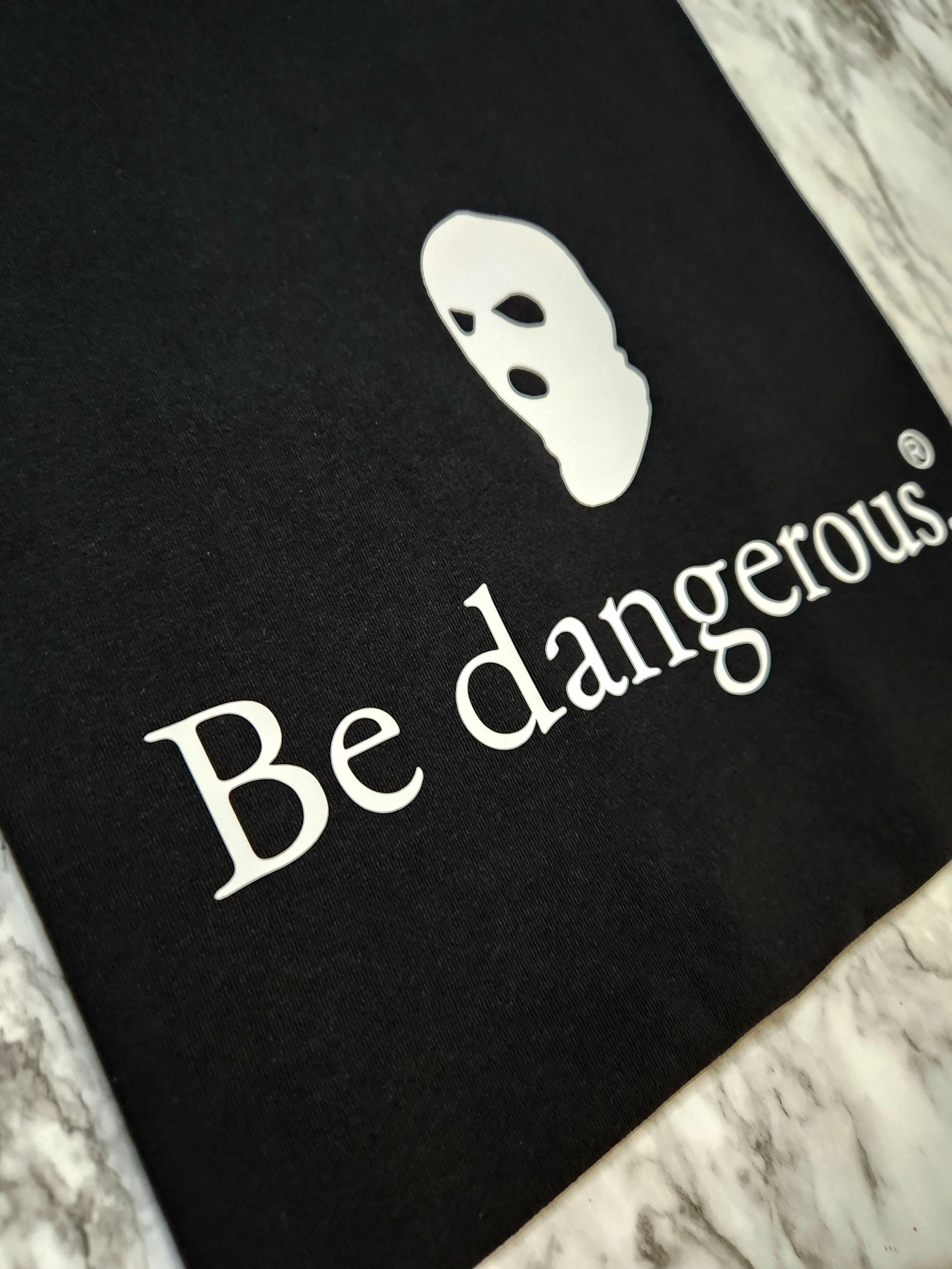 Be dangerous. T-Shirt
