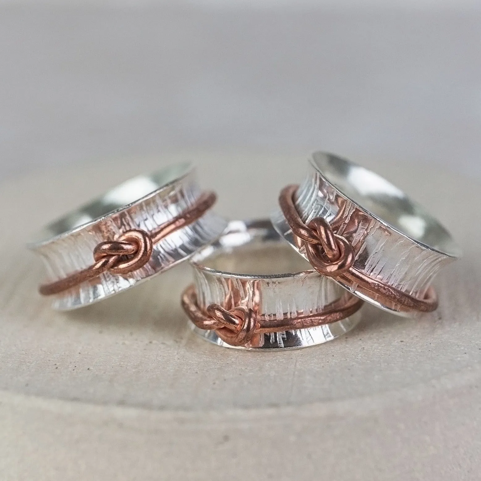 Sterling Silver and Copper Love Knot Spinner Rings